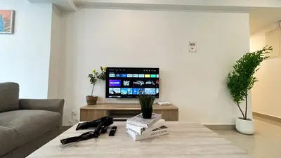 a living room with a couch and a tv at Fahrenheit 88 Bukit Bintang by Manhattan Group in Kuala Lumpur