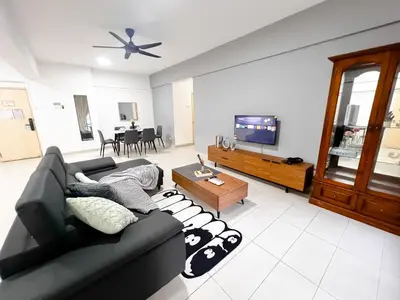 a living room with a black couch and a tv at Fahrenheit 88 Bukit Bintang by Manhattan Group in Kuala Lumpur