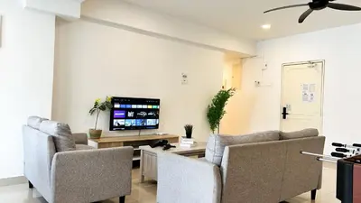 a living room with two chairs and a tv at Fahrenheit 88 Bukit Bintang by Manhattan Group in Kuala Lumpur