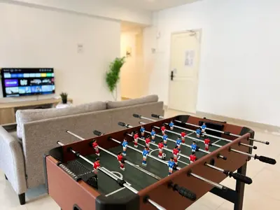 a foosball table in the middle of a living room at Fahrenheit 88 Bukit Bintang by Manhattan Group in Kuala Lumpur