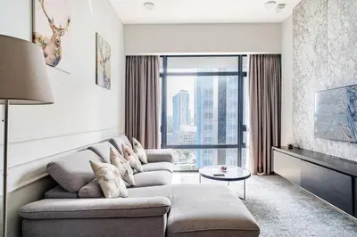 a living room with a couch and a large window at Designer Luxury Condo Near Bukit Bintang in Kuala Lumpur