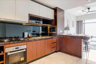 a large kitchen with wooden cabinets and a sink at Designer Luxury Condo Near Bukit Bintang in Kuala Lumpur