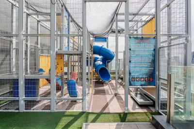 a playground with a blue slide in a building at Designer Luxury Condo Near Bukit Bintang in Kuala Lumpur