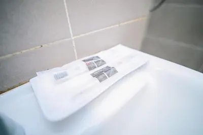 a bathroom with a white toilet and a sink at Swing & Pillows - TAR UMT Setapak in Kuala Lumpur