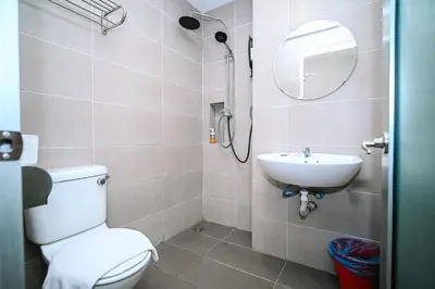 a bathroom with a toilet and a sink at Swing & Pillows - TAR UMT Setapak in Kuala Lumpur
