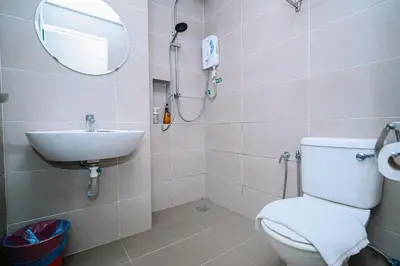 a bathroom with a toilet and a sink and a mirror at Swing & Pillows - TAR UMT Setapak in Kuala Lumpur