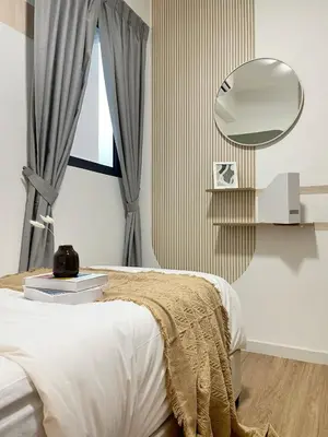 a bedroom with a bed and a round mirror at ISYAK Homestay Cheras M Vertika KL in Kuala Lumpur