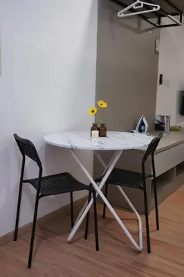 a white table with two chairs in a room at Riveria City KL Sentral by Nest Suite in Kuala Lumpur