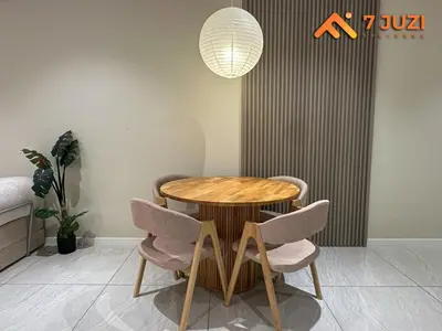 a wooden table and chairs in a room at KL Tower View Luxury Cozy& Spacious Suite 4-5 Pax in Kuala Lumpur