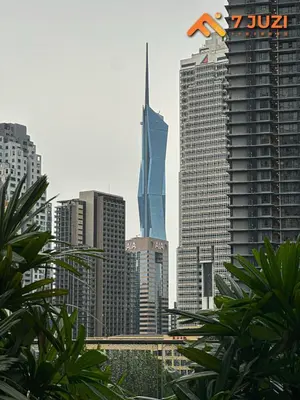 a view of a city skyline with a tall skyscraper at KL Tower View Luxury Cozy& Spacious Suite 4-5 Pax in Kuala Lumpur