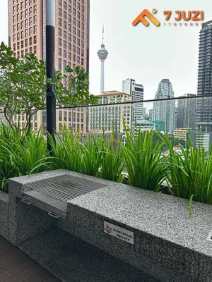 a stone bench with a view of a city at KL Tower View Luxury Cozy& Spacious Suite 4-5 Pax in Kuala Lumpur