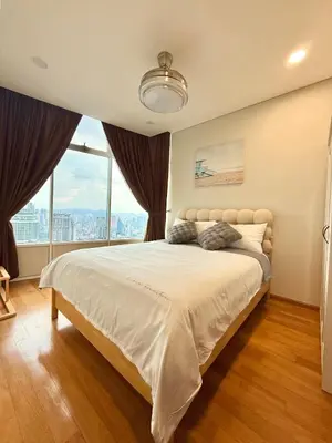 a bedroom with a large bed with a large window at Sky Suites Klcc By Stayner in Kuala Lumpur