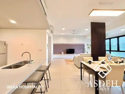 a kitchen and living room with a table and chairs at KaMi Mont Kiara Residences & Hotel by Ireka in Kuala Lumpur