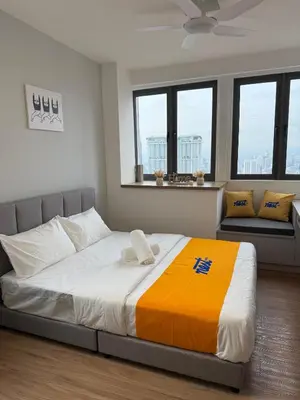 a large bed in a room with windows at Nest Haven KL in Kuala Lumpur