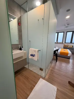 a bathroom with a shower and a sink and a bed at Nest Haven KL in Kuala Lumpur