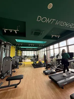 a gym with people exercising on treadmills in a building at Nest Haven KL in Kuala Lumpur