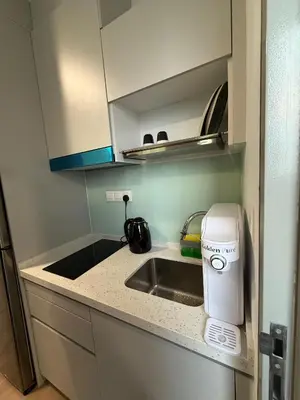 a small kitchen with a sink and a microwave at Nest Haven KL in Kuala Lumpur