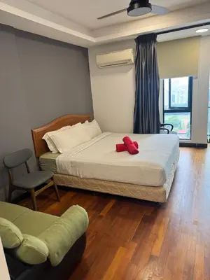a bedroom with a bed with a red object on it at Casa residency by relaxhome in Kuala Lumpur