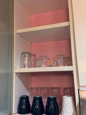 a row of glasses on a shelf at Casa residency by relaxhome in Kuala Lumpur
