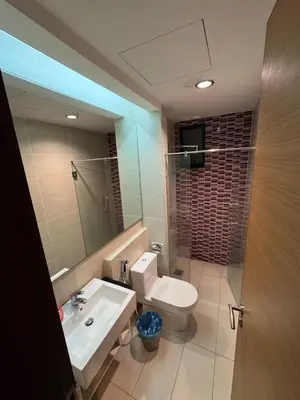 a bathroom with a sink and a toilet and a mirror at Casa residency by relaxhome in Kuala Lumpur