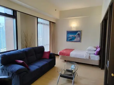 a living room with a couch and a bed at Twobedroom Hotel Apartment At Times Square Kuala Lumpur in Kuala Lumpur
