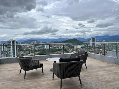 a balcony with chairs and a table on a building at Suite16 Kuala Lumpur in Kuala Lumpur
