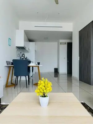 a vase with yellow flowers on a table in a kitchen at In