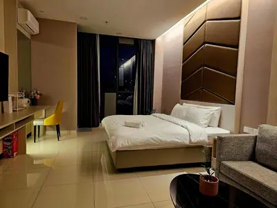 a bedroom with a bed and a desk and a couch at Societe Hartamas, Mont Kiara, Kuala Lumpur Golf in Kuala Lumpur