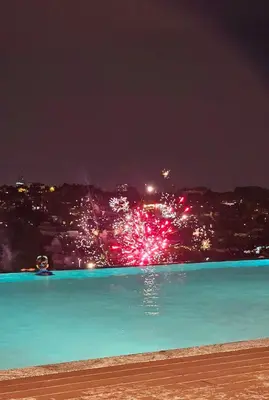a pool of water with fireworks at night at Societe Hartamas, Mont Kiara, Kuala Lumpur Golf in Kuala Lumpur