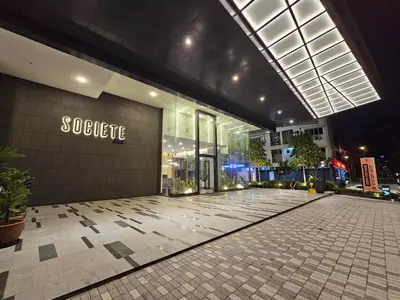 a large building with a store front at night at Societe Hartamas, Mont Kiara, Kuala Lumpur Golf in Kuala Lumpur