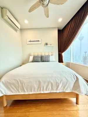 a bedroom with a large bed and a window at Sky Suites Klcc By Stayner in Kuala Lumpur
