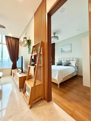 a bedroom with a bed and a wooden ladder at Sky Suites Klcc By Stayner in Kuala Lumpur