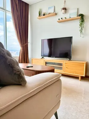 a living room with a couch and a flat screen tv at Sky Suites Klcc By Stayner in Kuala Lumpur