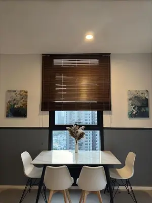 a dining room table with white chairs and a window at Arcoris Mont Kiara in Kuala Lumpur