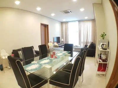 a dining room with a glass table and chairs at Soho Suites Pavilion by LSA in Kuala Lumpur