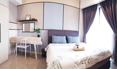 a small bedroom with a bed and a table at KL Mont Kiara The Ooak Entire Unit in Kuala Lumpur