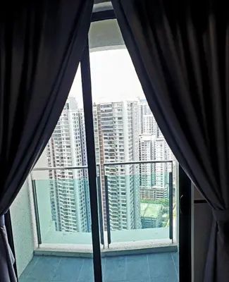 a window with black curtains and a view of a city at KL Mont Kiara The Ooak Entire Unit in Kuala Lumpur