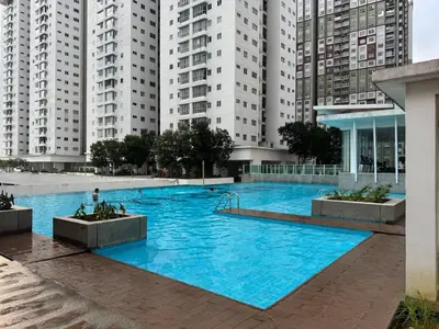 a large blue swimming pool in front of tall buildings at Maxim City Lights in Kuala Lumpur