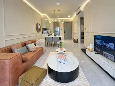 a living room with a brown couch and a tv at Agile Bukit Bintang TRX KL by Lilbean Space - 2B1R in Kuala Lumpur