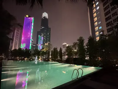 a large fountain in the middle of a city at night at Agile Bukit Bintang TRX KL by Lilbean Space - 2B1R in Kuala Lumpur