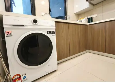 a white washing machine sitting in a room at Sunway Velocity Two Direct Link to Sunway Velocity Mall MRT TRX in Kuala Lumpur