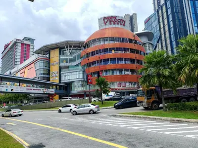 a city street with cars parked in front of a building at Sunway Velocity Two Direct Link to Sunway Velocity Mall MRT TRX in Kuala Lumpur