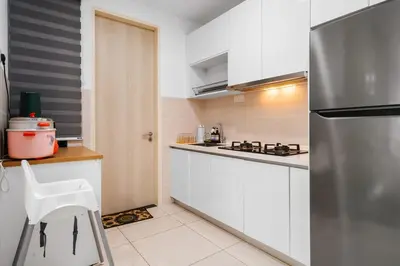 a kitchen with white cabinets and a stainless steel refrigerator at Legasi 3 Premium Bedroom With KLCC View 10min Walk to KLCC Comes With Board Games and PS4 Fit Up To 10PAX in Kuala Lumpur