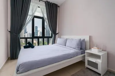 a bedroom with a bed with a large window at Legasi 3 Premium Bedroom With KLCC View 10min Walk to KLCC Comes With Board Games and PS4 Fit Up To 10PAX in Kuala Lumpur