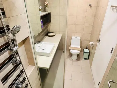 a small bathroom with a toilet and a sink at The Robertson Bukit Bintang in Kuala Lumpur