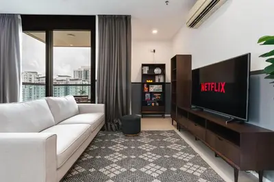 a living room with a white couch and a television at Arcoris Soho 163 Mall Luxury 2Bedroom With City View in Kuala Lumpur