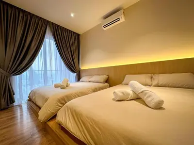 a hotel room with two beds and a window at The Luxury Quill Residence KLCC By Tasrifa in Kuala Lumpur