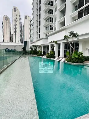 a swimming pool in front of a building at The Luxury Quill Residence KLCC By Tasrifa in Kuala Lumpur