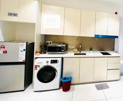 a kitchen with a washing machine and a refrigerator at The Luxury Quill Residence KLCC By Tasrifa in Kuala Lumpur