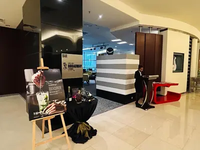 a man in a suit standing in a lobby at DYNAMIC SUITES by TIMES SQUARE KL in Kuala Lumpur